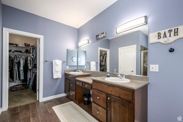 10453 N Canterbury Pl, Highland, UT 84003 - bathroom featuring a spacious closet, double vanity, wood finished floors, and a shower stall