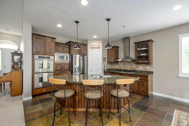 10453 N Canterbury Pl, Highland, UT 84003 - kitchen featuring wall chimney range hood, stainless steel appliances, backsplash, arched walkways, and stone tile floors