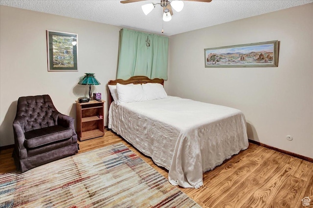 490 E 3475 N, North Ogden, UT 84414 - bedroom featuring light wood-style flooring, a textured ceiling, and ceiling fan