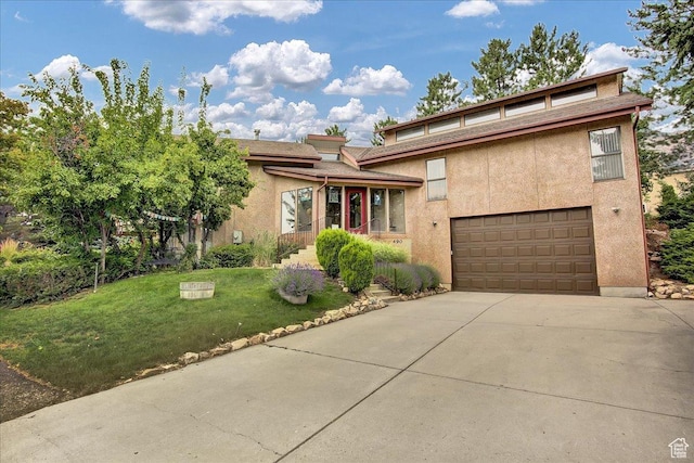 490 E 3475 N, North Ogden, UT 84414 - view of front of home featuring a garage, concrete driveway, a front lawn, and stucco siding