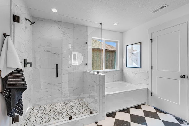 6957 W Farnsworth Peak Dr S Unit 314, West Jordan, UT 84081 - bathroom featuring a garden tub, a marble finish shower, recessed lighting, tile patterned floors, and a textured ceiling