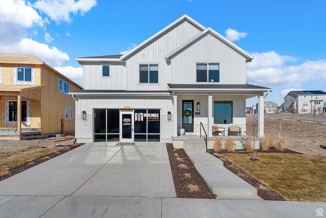 6957 W Farnsworth Peak Dr S Unit 314, West Jordan, UT 84081 - modern inspired farmhouse featuring a porch, board and batten siding, and driveway