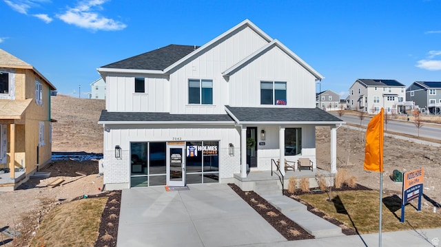 6957 W Farnsworth Peak Dr S Unit 314, West Jordan, UT 84081 - back of property with board and batten siding, covered porch, and roof with shingles