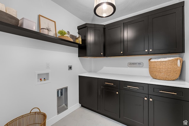 6957 W Farnsworth Peak Dr S Unit 314, West Jordan, UT 84081 - laundry room with cabinet space, hookup for an electric dryer, hookup for a washing machine, and light tile patterned floors