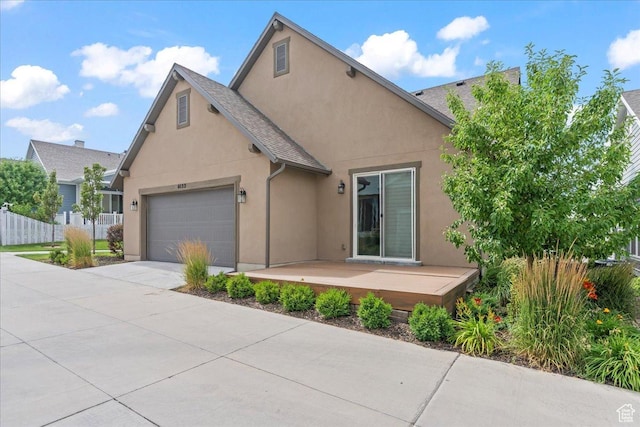 6153 W Poplar View Dr, South Jordan, UT 84009 - view of front of house featuring stucco siding, a garage, driveway, and a wooden deck