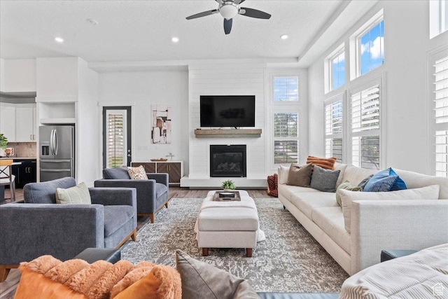 6153 W Poplar View Dr, South Jordan, UT 84009 - living room featuring wood finished floors, a ceiling fan, a large fireplace, and recessed lighting