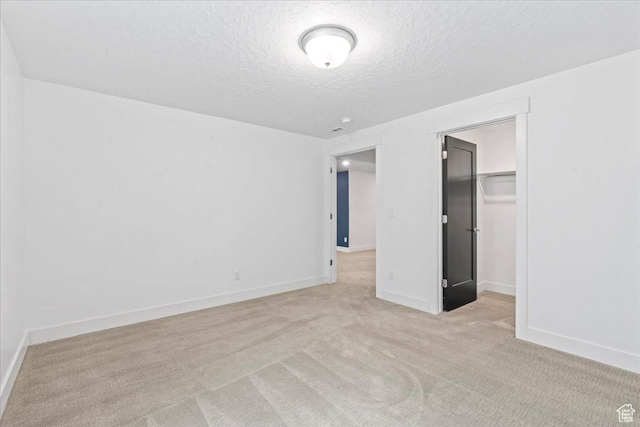 6153 W Poplar View Dr, South Jordan, UT 84009 - unfurnished bedroom with a textured ceiling, light carpet, a closet, and a spacious closet