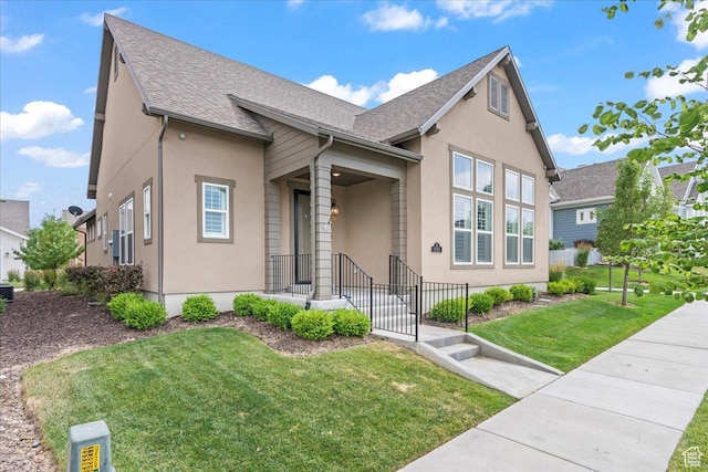 6153 W Poplar View Dr, South Jordan, UT 84009 - view of front of house featuring stucco siding, roof with shingles, and a front yard