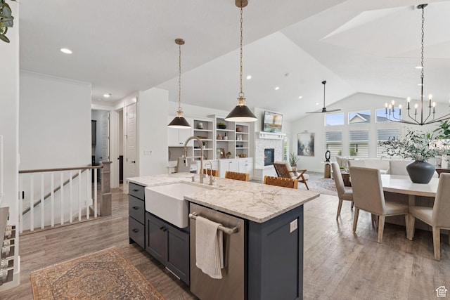 1968 W Silver Leaf Dr S, Mapleton, UT 84664 - kitchen featuring dishwasher, a fireplace, open floor plan, a chandelier, and wood finished floors