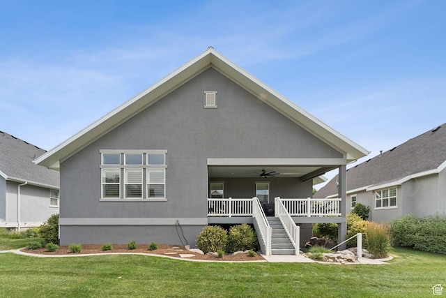 1968 W Silver Leaf Dr S, Mapleton, UT 84664 - back of property with a ceiling fan, a lawn, stucco siding, and stairs