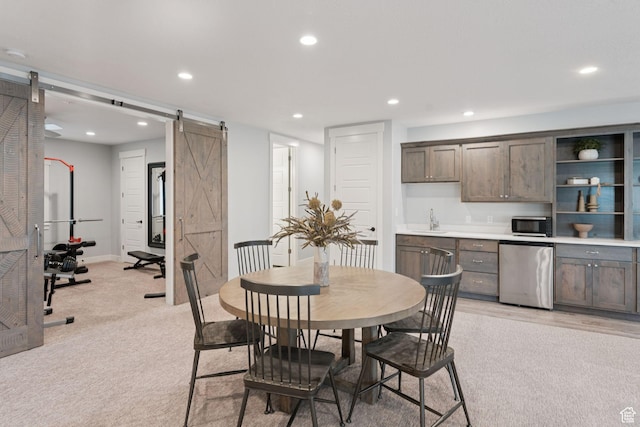 1968 W Silver Leaf Dr S, Mapleton, UT 84664 - dining area with a barn door, light colored carpet, recessed lighting, and bar with sink