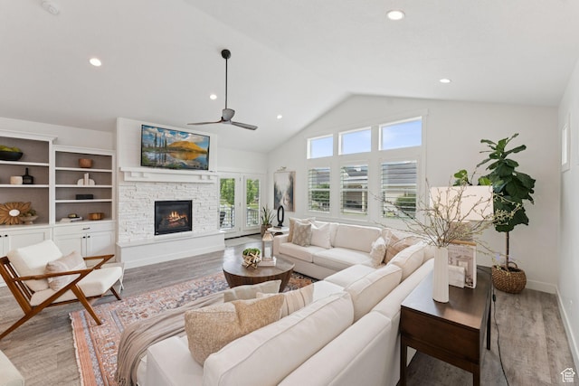 1968 W Silver Leaf Dr S, Mapleton, UT 84664 - living room featuring light wood-style floors, ceiling fan, a stone fireplace, recessed lighting, and high vaulted ceiling
