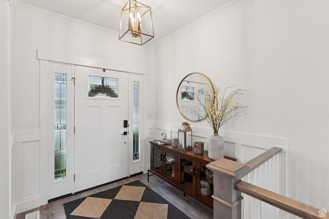 1968 W Silver Leaf Dr S, Mapleton, UT 84664 - entryway featuring wood finished floors, a decorative wall, a chandelier, ornamental molding, and a wainscoted wall