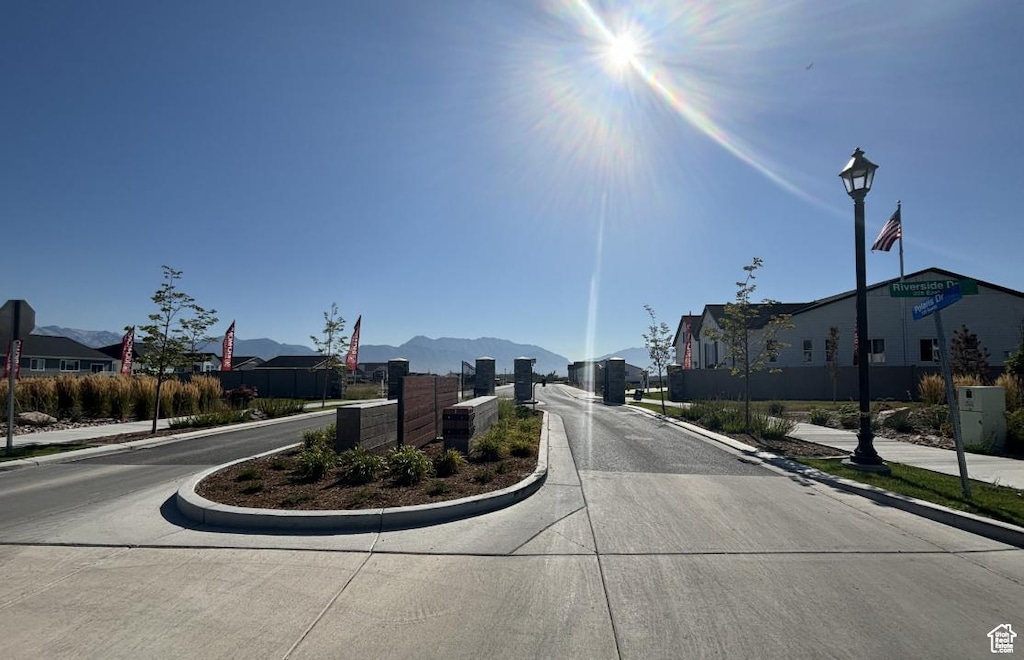 246 E Polaris Dr Unit 109, Saratoga Springs, UT 84045 - view of concrete road featuring curbs, sidewalks, and a residential view
