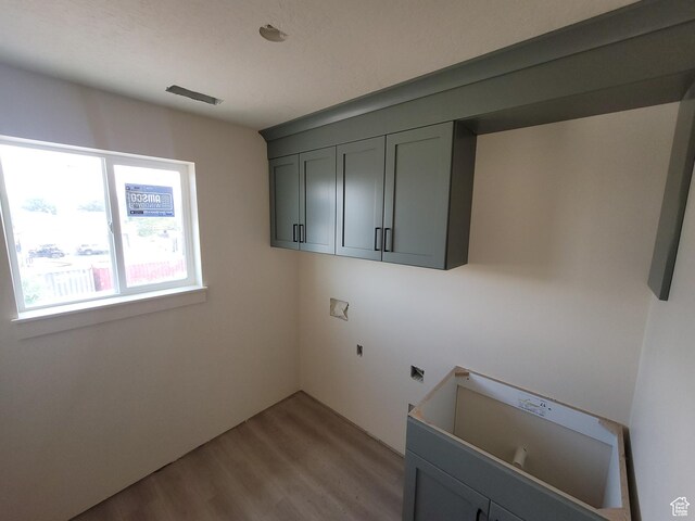 2909 S Richards View Rd Unit 6, Magna, UT 84044 - laundry room featuring electric dryer hookup, light wood finished floors, hookup for a washing machine, and cabinet space