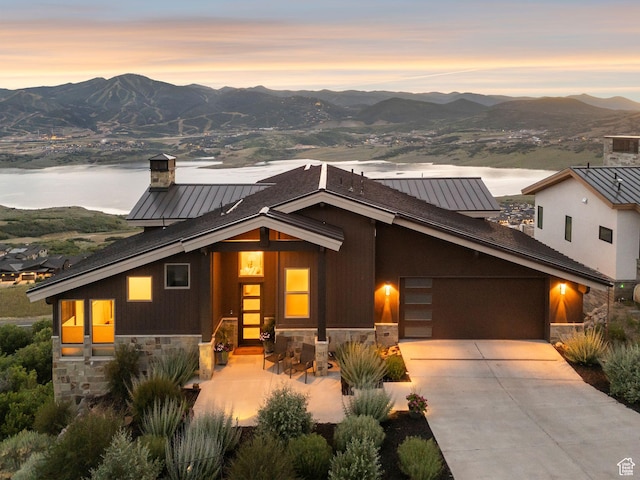 11411 N White Tail Ct, Hideout, UT 84036 - view of front of property with stone siding, a mountain view, and a garage