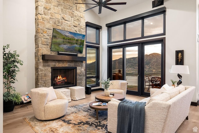 11411 N White Tail Ct, Hideout, UT 84036 - living area with ceiling fan, a fireplace, wood finished floors, and high vaulted ceiling