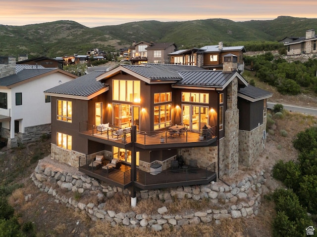 11411 N White Tail Ct, Hideout, UT 84036 - back of property featuring stone siding, a standing seam roof, a metal roof, and a mountain view