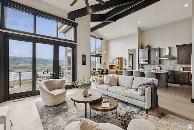 11411 N White Tail Ct, Hideout, UT 84036 - living room with beamed ceiling, light wood finished floors, high vaulted ceiling, ceiling fan, and recessed lighting