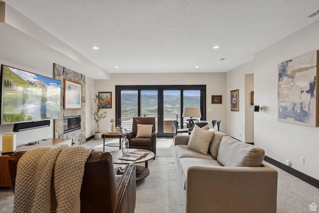 11411 N White Tail Ct, Hideout, UT 84036 - living area with light carpet, a stone fireplace, recessed lighting, and a textured ceiling