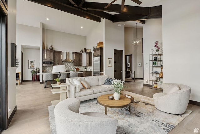 11411 N White Tail Ct, Hideout, UT 84036 - living area with high vaulted ceiling, light wood-style flooring, ceiling fan, beam ceiling, and a chandelier