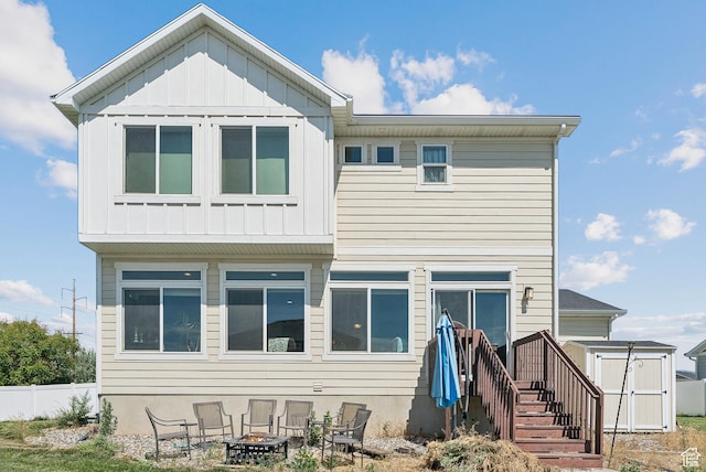 979 N Cold Creek Way, Layton, UT 84041 - back of property with an outdoor fire pit, a storage shed, and board and batten siding
