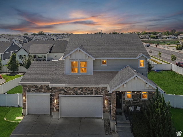 979 N Cold Creek Way, Layton, UT 84041 - view of front facade with board and batten siding, driveway, stone siding, and roof with shingles