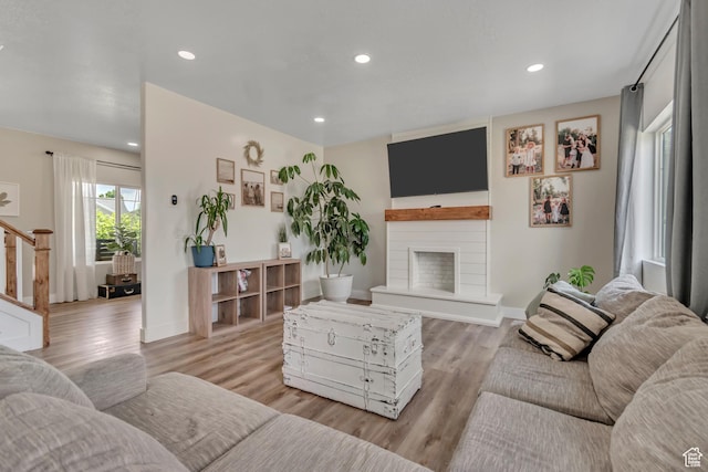 342 W Royal Land Dr, Santaquin, UT 84655 - living room with a fireplace with raised hearth, light wood finished floors, stairway, and recessed lighting