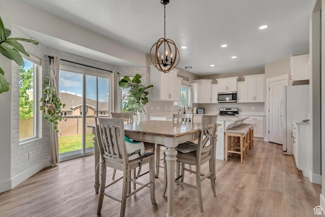 342 W Royal Land Dr, Santaquin, UT 84655 - dining space with light wood-style flooring, a chandelier, and recessed lighting