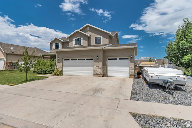 342 W Royal Land Dr, Santaquin, UT 84655 - traditional-style house with stucco siding, driveway, an attached garage, stone siding, and a front yard
