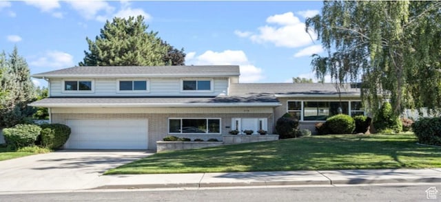 678 W 650 S, Orem, UT 84058 - split level home with concrete driveway, a garage, a front yard, and brick siding