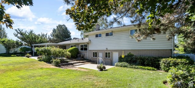 678 W 650 S, Orem, UT 84058 - rear view of house with a lawn, brick siding, and a patio