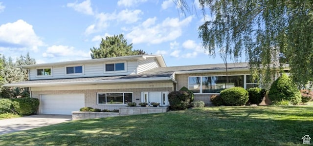 678 W 650 S, Orem, UT 84058 - split level home featuring brick siding, driveway, a front lawn, and a garage