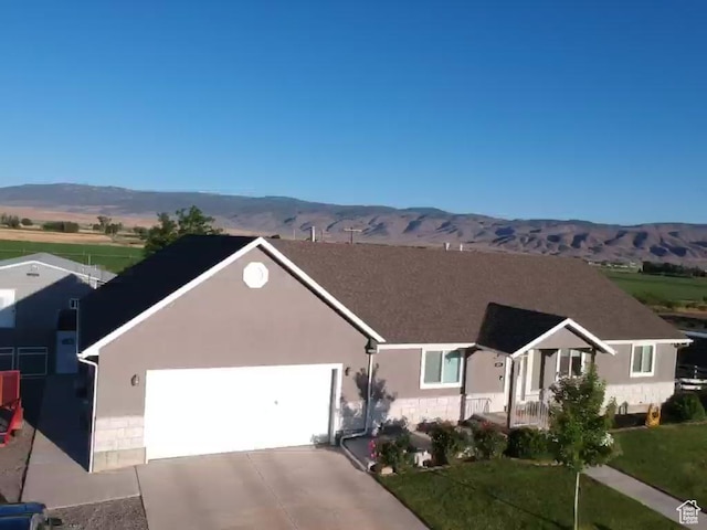 251 N 580 W, Monroe, UT 84754 - ranch-style house with a mountain view, an attached garage, concrete driveway, and stucco siding