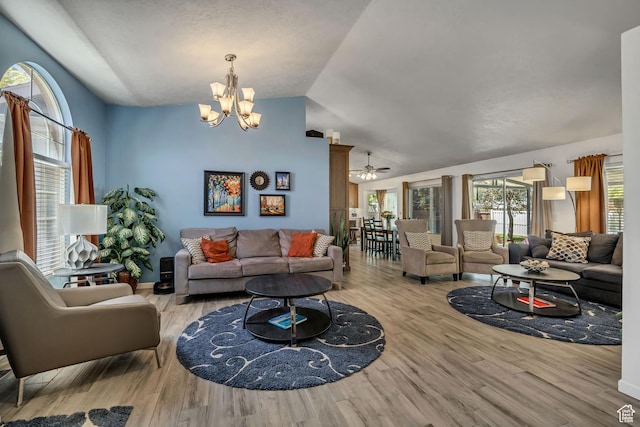 9078 S Harkness Dr W, West Jordan, UT 84088 - living room featuring a chandelier, lofted ceiling, wood finished floors, and a ceiling fan