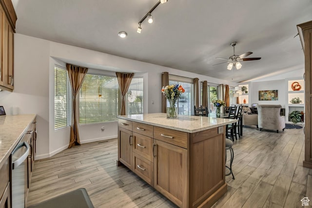 9078 S Harkness Dr W, West Jordan, UT 84088 - kitchen featuring dishwasher, ceiling fan, light wood-style flooring, lofted ceiling, and a kitchen breakfast bar