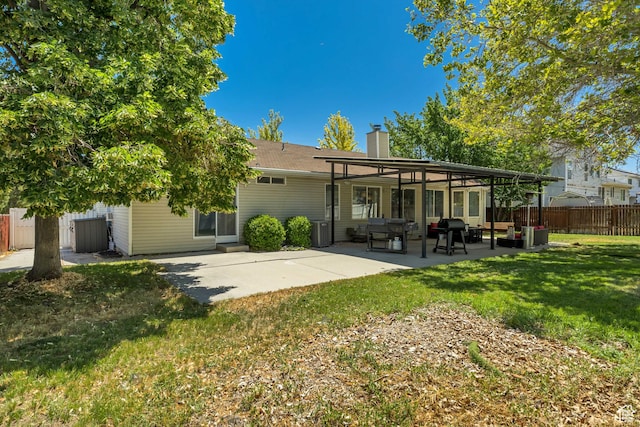 9078 S Harkness Dr W, West Jordan, UT 84088 - back of house featuring a chimney and a patio area