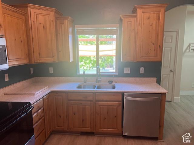 5298 W Icehouse Way, West Jordan, UT 84081 - kitchen featuring dishwasher, light countertops, light wood finished floors, electric range, and arched walkways