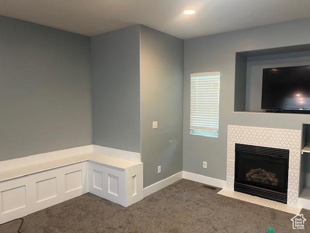 5298 W Icehouse Way, West Jordan, UT 84081 - unfurnished living room featuring dark carpet and a tiled fireplace