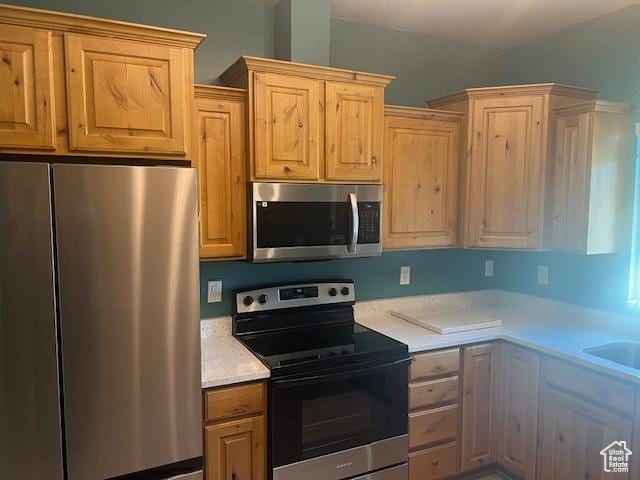 5298 W Icehouse Way, West Jordan, UT 84081 - kitchen featuring stainless steel appliances, light countertops, and light brown cabinetry