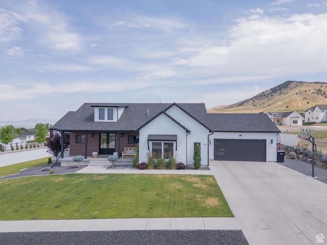 142 N 1100 E, Hyde Park, UT 84318 - modern inspired farmhouse featuring a mountain view, a garage, driveway, french doors, and covered porch