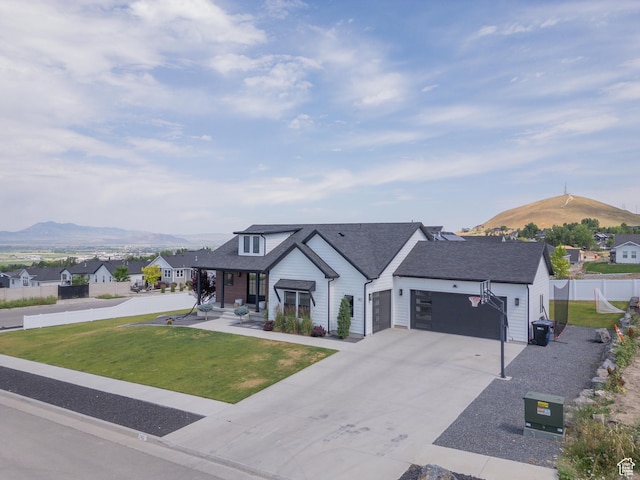 142 N 1100 E, Hyde Park, UT 84318 - modern inspired farmhouse featuring a mountain view, an attached garage, a residential view, and concrete driveway