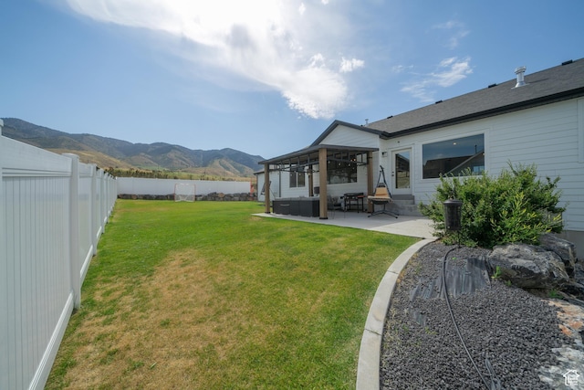 142 N 1100 E, Hyde Park, UT 84318 - fenced backyard with a mountain view, a patio area, entry steps, and an outdoor hangout area