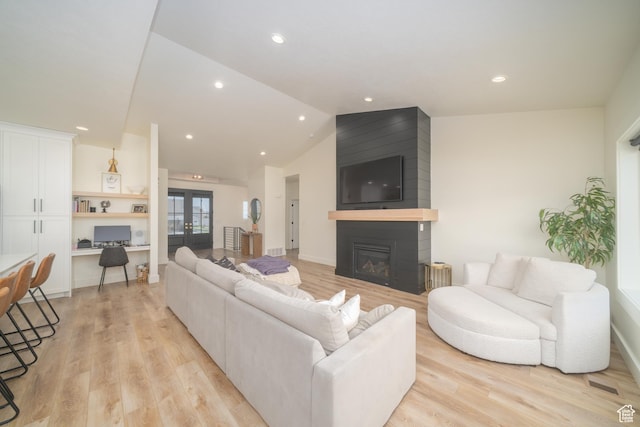 142 N 1100 E, Hyde Park, UT 84318 - living room featuring light wood-style floors, a large fireplace, recessed lighting, vaulted ceiling, and french doors