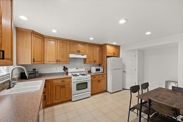 2188 E Country View Ln, Cottonwood Heights, UT 84121 - kitchen with white appliances, under cabinet range hood, light flooring, recessed lighting, and light countertops