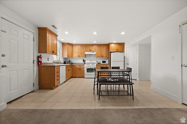 2188 E Country View Ln, Cottonwood Heights, UT 84121 - kitchen with white appliances, under cabinet range hood, recessed lighting, and brown cabinets