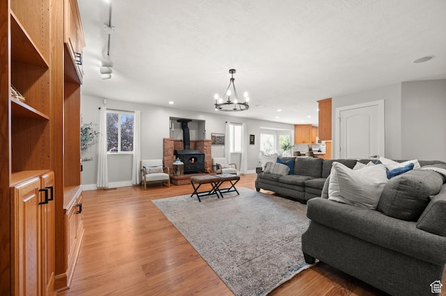 2188 E Country View Ln, Cottonwood Heights, UT 84121 - living area featuring light wood-style flooring, a chandelier, a wood stove, and recessed lighting