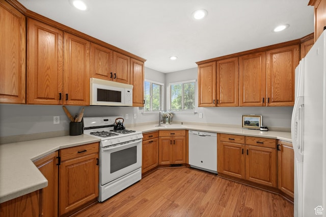 2188 E Country View Ln, Cottonwood Heights, UT 84121 - kitchen with white appliances, brown cabinetry, light wood finished floors, and recessed lighting