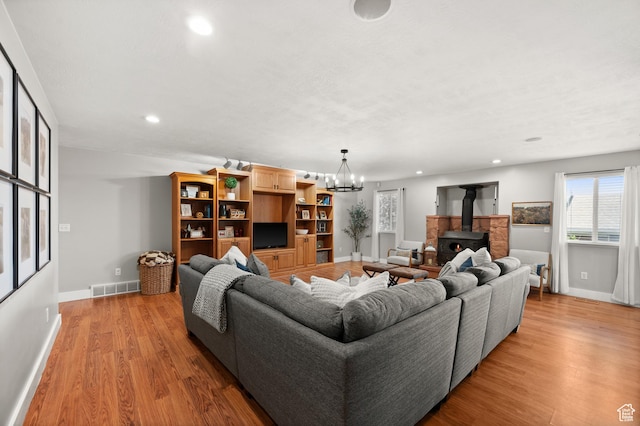 2188 E Country View Ln, Cottonwood Heights, UT 84121 - living area featuring recessed lighting, light wood-style flooring, a wood stove, and a chandelier