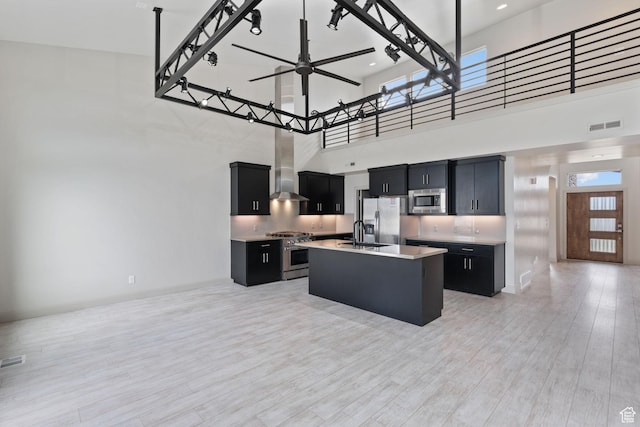 2628 E 40 N Unit 9, Spanish Fork, UT 84660 - kitchen featuring stainless steel appliances, dark cabinets, wall chimney exhaust hood, a towering ceiling, and light countertops